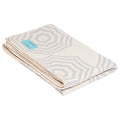 Grace Beauty Atlanta grey parasol throw blanket on a bed, cozy and soft for single size beds, perfect for bedroom decor.