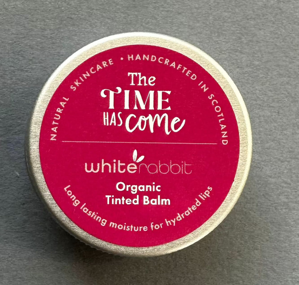 White Rabbit Skin Care organic tinted balm on lips, showing natural color and smooth texture for lips and cheeks.