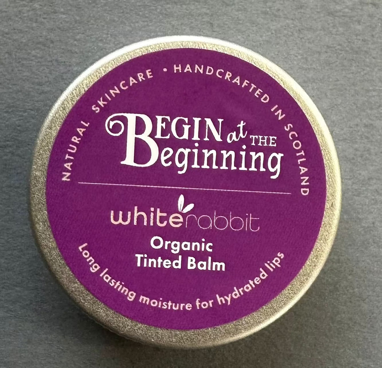 White Rabbit Skin Care organic tinted lip balm and moisturizer showing natural shades on lips and cheeks.