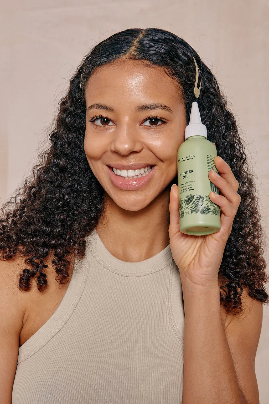Batanaful Wonder Oil with Batana and Rosemary, multi-use hair and scalp treatment in a clear bottle with dropper.