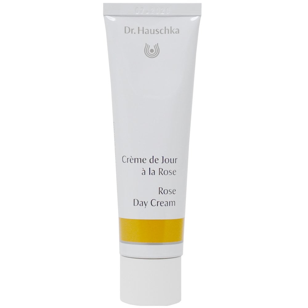 Dr. Hauschka Rose Day Cream 30ml moisturizer in a jar, suitable for sensitive skin, displayed with fresh roses in the background.